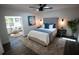 Bedroom featuring a tufted headboard, plush carpet, and sunny sitting area, creating a cozy retreat at 4452 Fairview Ave, Orlando, FL 32804