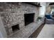 Close-up of the brick fireplace with TV and a plant on the mantel in the living room at 4452 Fairview Ave, Orlando, FL 32804