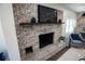 Living room boasting an eye-catching brick fireplace, a wood mantle, and a cozy seating area at 4452 Fairview Ave, Orlando, FL 32804