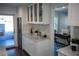 Well-lit kitchen with a wine cooler and white cabinets, adjacent to a charming office space at 4452 Fairview Ave, Orlando, FL 32804