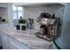 Beautiful kitchen with stainless steel coffee maker, white cabinetry, and marble countertops at 4452 Fairview Ave, Orlando, FL 32804