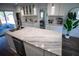 Open kitchen island features marble countertops, modern sink, and stylish pendant lighting at 4452 Fairview Ave, Orlando, FL 32804