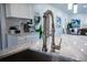 Close-up on a kitchen with a stainless steel faucet and a marble countertop at 4452 Fairview Ave, Orlando, FL 32804