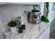 Stylish kitchen countertop with modern coffee maker, white cabinets, and grey backsplash at 4452 Fairview Ave, Orlando, FL 32804