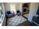 Cozy living room with plush seating, a fireplace, and natural light from a large window at 4452 Fairview Ave, Orlando, FL 32804