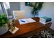 Cozy office featuring a wooden desk with decor and view into an adjacent bathroom at 4452 Fairview Ave, Orlando, FL 32804