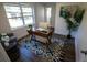 Bright office with a vintage desk, blue rug, and a sunlit window at 4452 Fairview Ave, Orlando, FL 32804