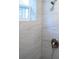 Close-up of a modern shower with white tiled walls, window and rainfall shower head at 4452 Fairview Ave, Orlando, FL 32804