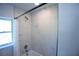 Shower area featuring white marble tiles, a rainfall showerhead, and glass door at 4452 Fairview Ave, Orlando, FL 32804