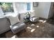 Cozy sitting area with two chairs, plush rug, and natural light streaming through the window at 4452 Fairview Ave, Orlando, FL 32804