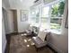 Inviting sitting area with cozy chairs, plush rug, and a view to the backyard at 4452 Fairview Ave, Orlando, FL 32804