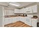 Bright kitchen featuring white cabinets, wood countertops, and hardwood flooring at 451 Hunter Cir, Kissimmee, FL 34758