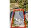 Overhead shot of a modern home near a golf course showcasing a manicured lawn and gray roofing at 480 Muirfield Loop, Reunion, FL 34747