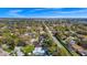 Aerial view of property in a tree-lined neighborhood featuring a private pool at 4826 S Saint Brides Cir, Orlando, FL 32812