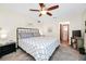 A primary bedroom showcasing a neutral color palette, carpeted floors, and an ensuite bathroom at 4826 S Saint Brides Cir, Orlando, FL 32812