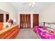 Inviting bedroom featuring a comfortable bed, classic wooden dresser, and natural light at 4826 S Saint Brides Cir, Orlando, FL 32812