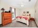 Inviting bedroom featuring a comfortable bed, classic wooden dresser, and natural light at 4826 S Saint Brides Cir, Orlando, FL 32812