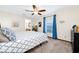 Cozy bedroom featuring a ceiling fan, plush carpeting, and serene decor and ensuite bathroom at 4826 S Saint Brides Cir, Orlando, FL 32812