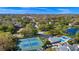 Aerial view of neighborhood amenities including a pool, tennis courts, and clubhouse in a tree-lined community at 4826 S Saint Brides Cir, Orlando, FL 32812