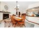 An open dining area is complimented by a stone fireplace and tile floors at 4826 S Saint Brides Cir, Orlando, FL 32812