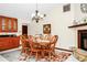 The dining area features tile flooring, a chandelier, and a stone fireplace at 4826 S Saint Brides Cir, Orlando, FL 32812