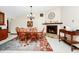 The dining area features tile floors, a chandelier, and a stone fireplace at 4826 S Saint Brides Cir, Orlando, FL 32812