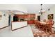 The kitchen connects to the dining area with wood cabinets, granite countertops, and tile flooring at 4826 S Saint Brides Cir, Orlando, FL 32812