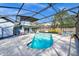 Relaxing screened-in pool area features a freeform pool, lounge chairs and an outdoor dining set for entertainment at 4826 S Saint Brides Cir, Orlando, FL 32812