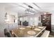 Open-concept dining area with modern light fixture, bench seating, and seamless flow into the kitchen at 509 Shane Cir, Winter Springs, FL 32708