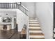 Inviting entryway featuring stairs, a bench, and a glimpse into a stylish living room at 509 Shane Cir, Winter Springs, FL 32708