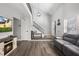 Open floor plan living room featuring a fireplace, sofa, and staircase leading to the second floor at 509 Shane Cir, Winter Springs, FL 32708