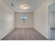 A cozy bedroom featuring soft gray carpet and a sunlit window at 5095 Caspian St, St Cloud, FL 34771