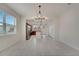 Bright dining area with a modern chandelier and view into the open kitchen at 5095 Caspian St, St Cloud, FL 34771