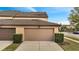 Attached two-car garage featuring concrete driveway and manicured landscaping at 5095 Caspian St, St Cloud, FL 34771