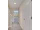 Neutral hallway leading to a room with a window and blinds at 5095 Caspian St, St Cloud, FL 34771