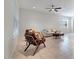 Inviting living room with tile floors, comfortable seating, and a ceiling fan at 5095 Caspian St, St Cloud, FL 34771