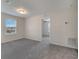 Living room with neutral walls and carpet, plus a window with blinds at 5095 Caspian St, St Cloud, FL 34771