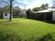 Lush green backyard with a storage shed and ample space for outdoor activities at 5121 Hoperita St, Orlando, FL 32812