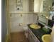 Retro bathroom with a yellow sink, tiled walls, and vintage fixtures at 5121 Hoperita St, Orlando, FL 32812