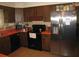 Traditional style kitchen featuring stainless steel refrigerator and black appliances at 5121 Hoperita St, Orlando, FL 32812