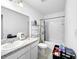 Bright bathroom with vanity sink, granite countertop, tiled backsplash, and shower-tub combination at 532 Madison Dr, Davenport, FL 33837