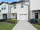 Inviting townhouse with a well-maintained lawn, complemented by an attached single car garage and modern design at 532 Madison Dr, Davenport, FL 33837