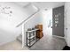 Inviting hallway with carpet leading to a living space, featuring decorative accents and a staircase at 532 Madison Dr, Davenport, FL 33837