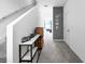 Bright hallway with carpet, leading to a living area, decorated with stylish accents and a staircase to the left at 532 Madison Dr, Davenport, FL 33837