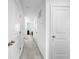 Carpeted hallway with white trim, featuring multiple doorways and recessed lighting at 532 Madison Dr, Davenport, FL 33837