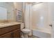 Bright bathroom with tile flooring, wood vanity, and white tub with shower at 7517 Laureate Blvd # 4103, Orlando, FL 32827