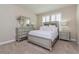 Bedroom featuring neutral carpet, silver bedroom set and shuttered windows at 7517 Laureate Blvd # 4103, Orlando, FL 32827