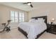 Comfortable bedroom with a king-size bed, neutral decor, and an exercise bike at 7517 Laureate Blvd # 4103, Orlando, FL 32827