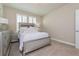 Cozy bedroom offers neutral carpet, silver bedroom set and shuttered windows at 7517 Laureate Blvd # 4103, Orlando, FL 32827