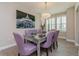 Elegant dining room featuring a mirrored table, tufted chairs, and decorative chandelier at 7517 Laureate Blvd # 4103, Orlando, FL 32827